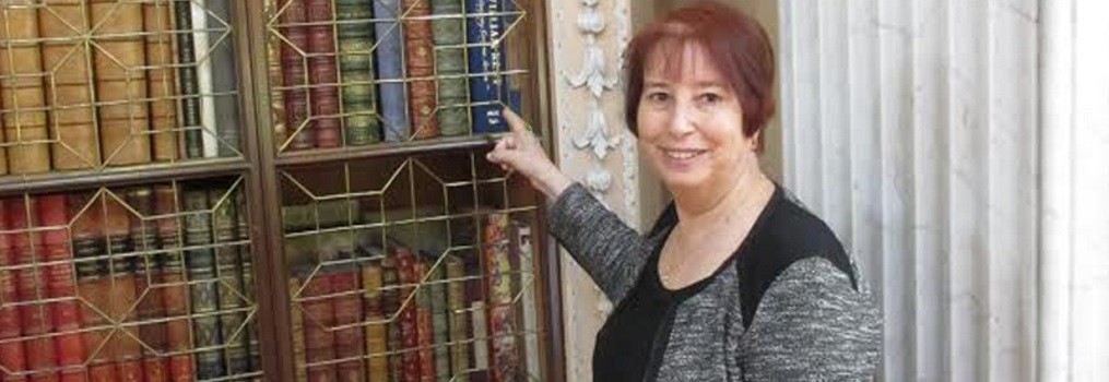 Enid L. Zafran, at Blenheim Palace, Oxfordshire, England (2014), pointing at a book she indexed in the library's collection.