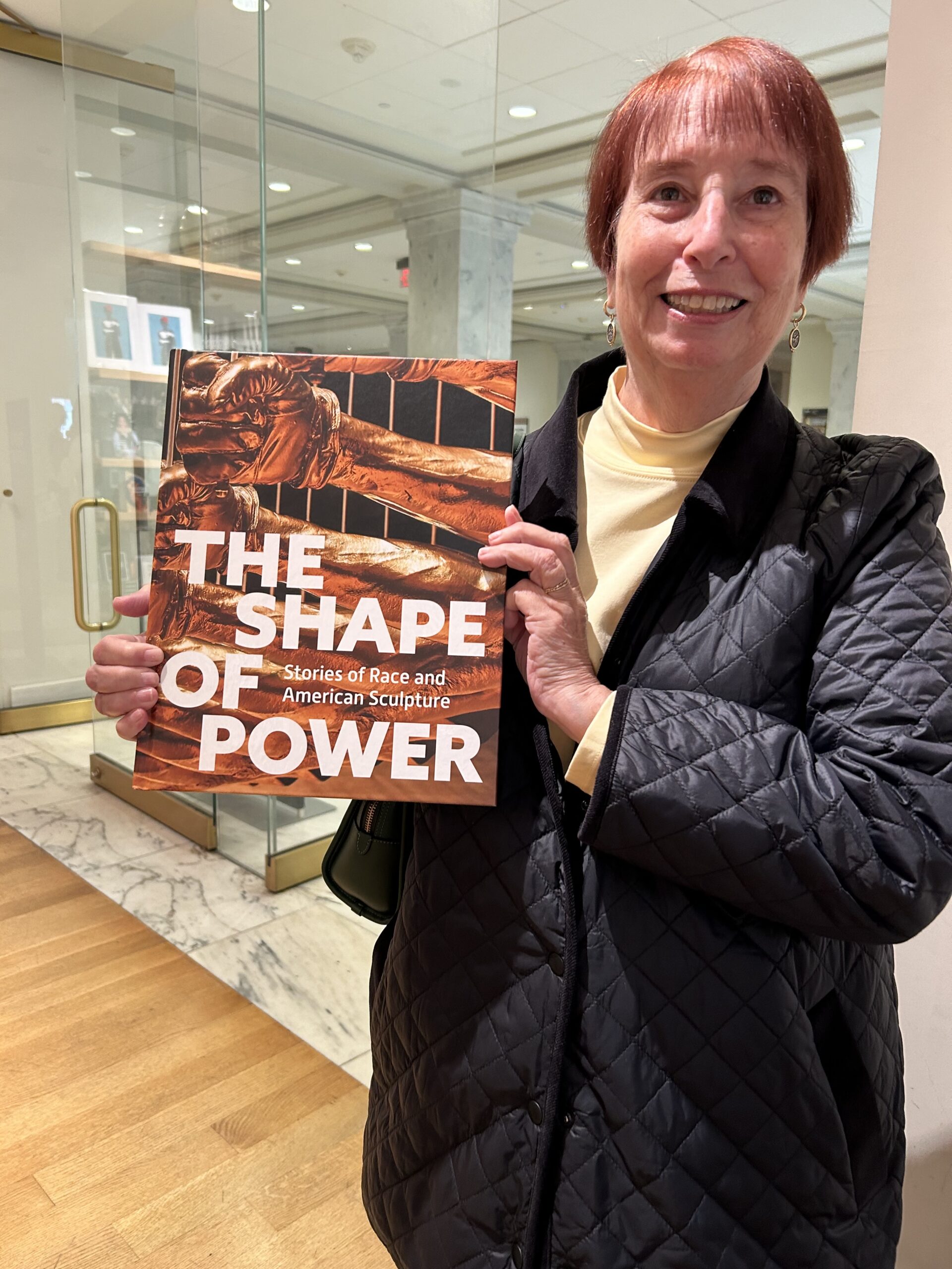 Enid Zafran holding book she indexed for 2024 exhibit at Smithsonian American Art Museum.